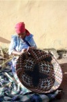 South African lady weaving a basket